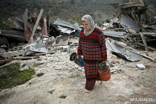 Palestinians inspect a house which was demolished by Israeli army in the occupied West Bank city of Nablus on December 21, 2011. Photo by Wagdi Eshtayah.
