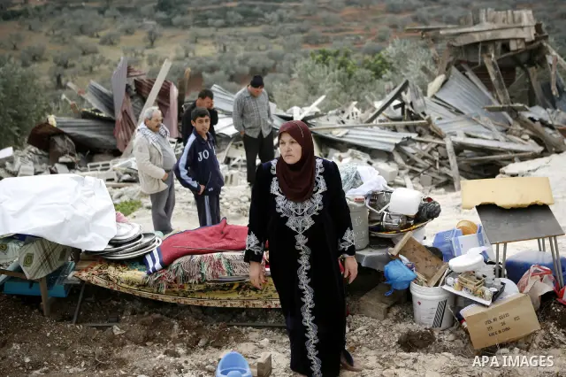 Palestinians inspect a house which was demolished by Israeli army in the occupied West Bank city of Nablus on December 21, 2011. Photo by Wagdi Eshtayah.