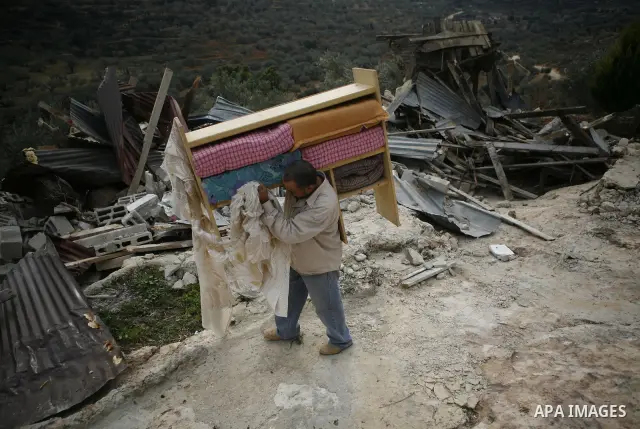 Palestinians inspect a house which was demolished by Israeli army in the occupied West Bank city of Nablus on December 21, 2011. Photo by Wagdi Eshtayah.