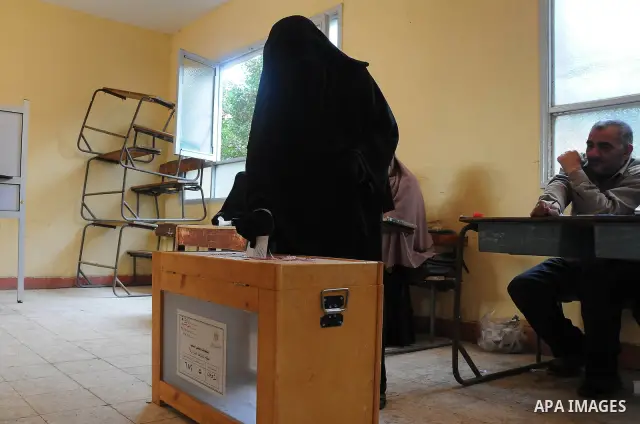 A veiled Egyptian woman casts her vote at a polling center in Giza, Egypt Wednesday, Dec. 21, 2011. Voting in election runoffs for Egypt's first parliament since Hosni Mubarak's ouster resumed on Wednesday without the lo...