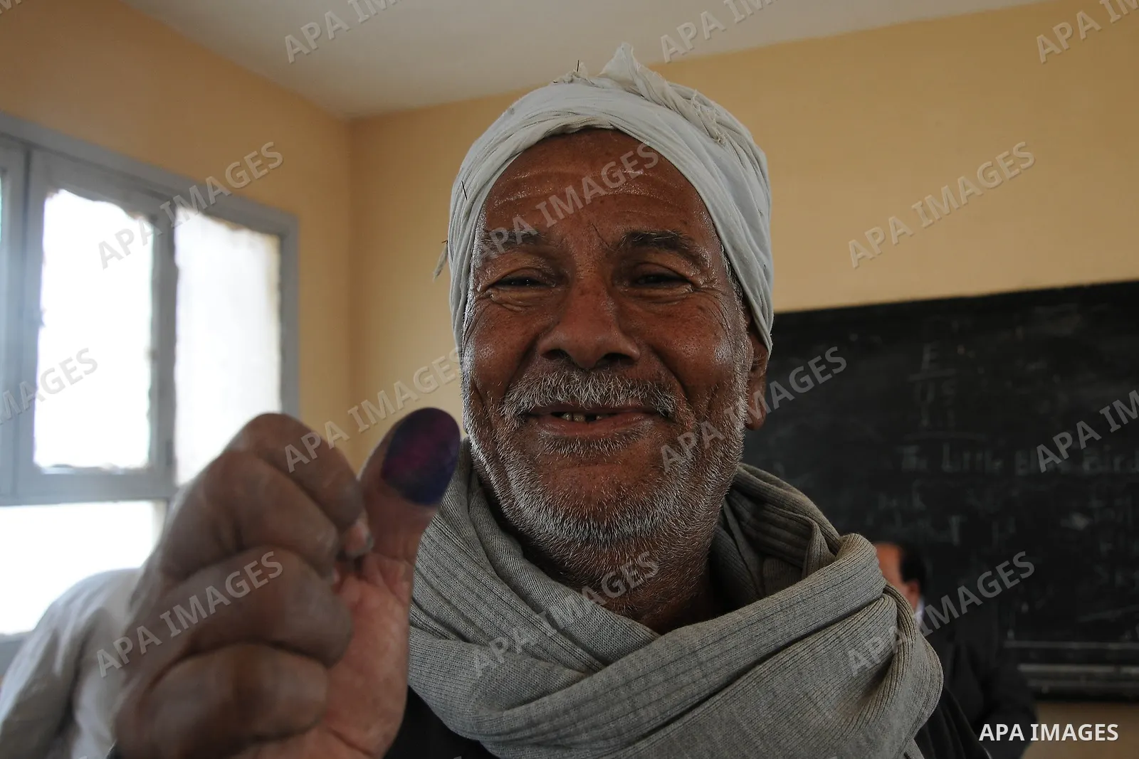 An Egyptian man shows his ink-stained finger after she voted at a polling station in Giza district near Cairo on December 21, 2011 in the run-off of the second round of legislative election marred by deadly clashes betwe...