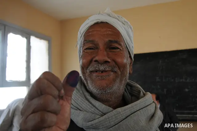 An Egyptian man shows his ink-stained finger after she voted at a polling station in Giza district near Cairo on December 21, 2011 in the run-off of the second round of legislative election marred by deadly clashes betwe...