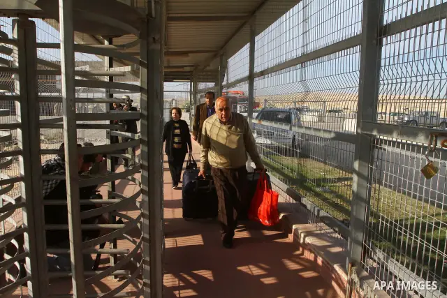 A Christian Palestinian family leaves Gaza to enter Israel through the Erez border crossing between Israel and northern Gaza Strip on Dec. 22,2011. The Israeli army on Thursday allowed some 550 Christian Palestinians to...