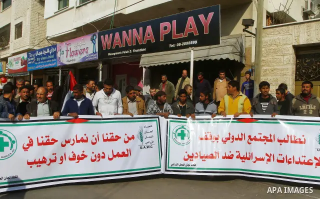 Palestinian fishermen take part in a protest in front of the Red Cross a protest against the Israel army assaults on fishermen in Gaza City, on Dec. 22. 2011. Photo by Ashraf Amra
