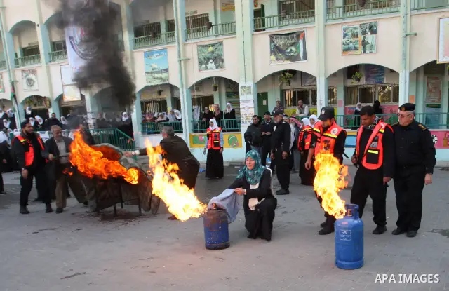 Palestinian schoolgirls take part in a civil defence exercises at a school in Rafah, in the southern of Gaza Strip on December 22, 2011. Photo by Abed Rahim Khatib