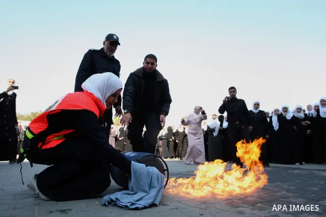 Palestinian schoolgirls take part in a civil defence exercises at a school in Rafah, in the southern of Gaza Strip on December 22, 2011. Photo by Abed Rahim Khatib