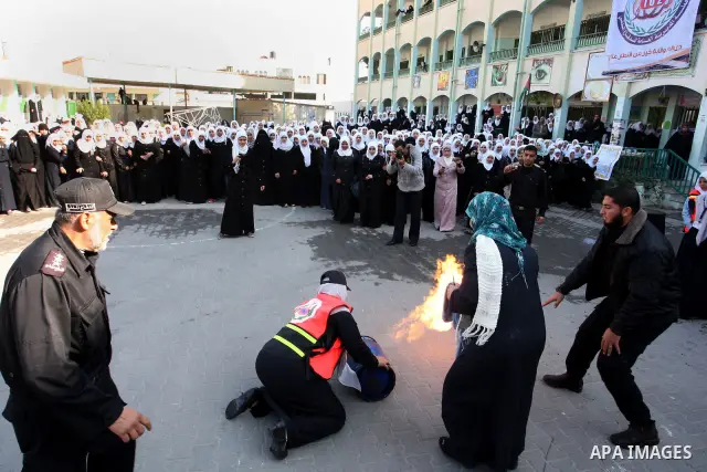 Palestinian schoolgirls take part in a civil defence exercises at a school in Rafah, in the southern of Gaza Strip on December 22, 2011. Photo by Abed Rahim Khatib