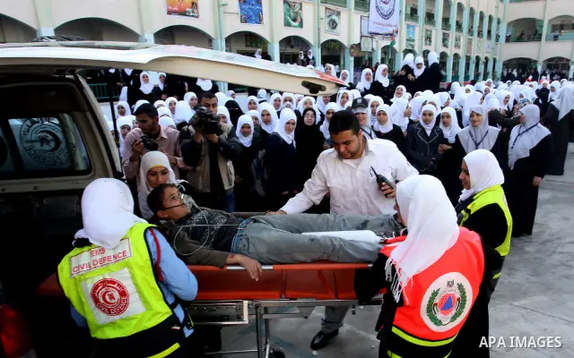Palestinian schoolgirls take part in a civil defence exercises at a school in Rafah, in the southern of Gaza Strip on December 22, 2011. Photo by Abed Rahim Khatib
