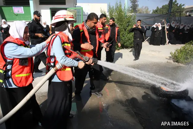 Palestinian schoolgirls take part in a civil defence exercises at a school in Rafah, in the southern of Gaza Strip on December 22, 2011. Photo by Abed Rahim Khatib