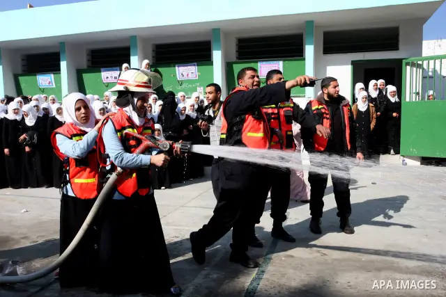 Palestinian schoolgirls take part in a civil defence exercises at a school in Rafah, in the southern of Gaza Strip on December 22, 2011. Photo by Abed Rahim Khatib
