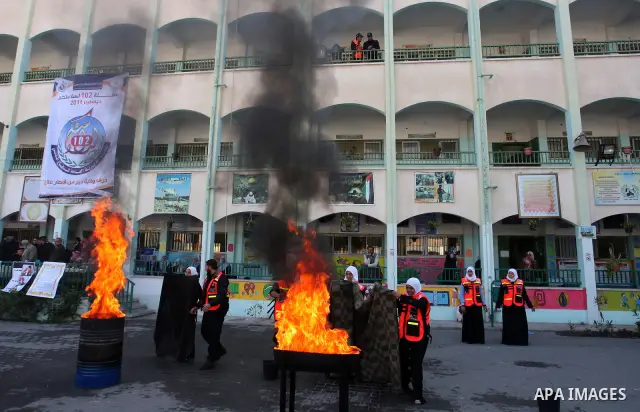Palestinian schoolgirls take part in a civil defence exercises at a school in Rafah, in the southern of Gaza Strip on December 22, 2011. Photo by Abed Rahim Khatib