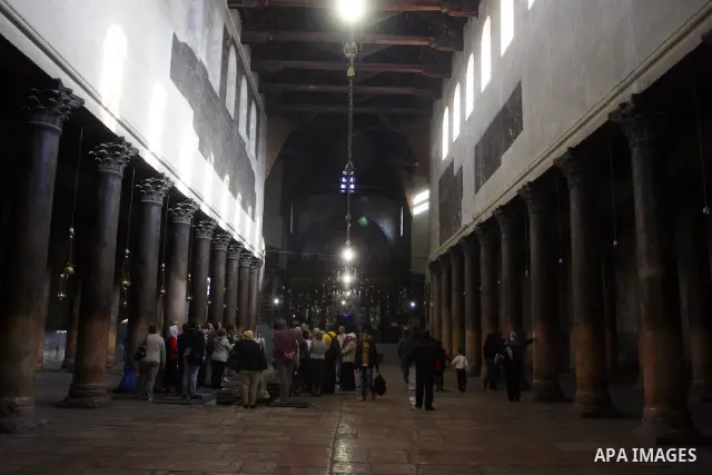 Christian pilgrims visit the Church of the Nativity in the biblical West Bank city of Bethlehem on 22 December 2011 as Christian pilgrims start gathering in the church belived to be the birthplace of Jesus Christ to cele...