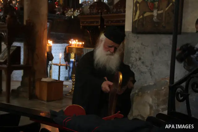 Christian pilgrims pray in the Church of the Nativity in the biblical West Bank city of Bethlehem on December 22, 2011, as Christian pilgrims started gathering in the traditional birthplace of Jesus Christ to attend the...