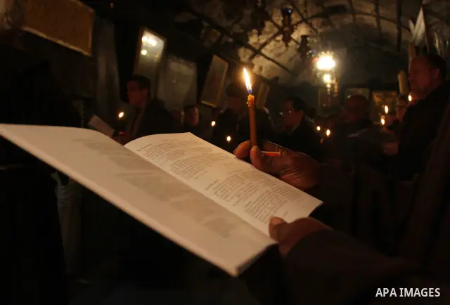 Christian pilgrims pray in the Church of the Nativity in the biblical West Bank city of Bethlehem on December 22, 2011, as Christian pilgrims started gathering in the traditional birthplace of Jesus Christ to attend the...