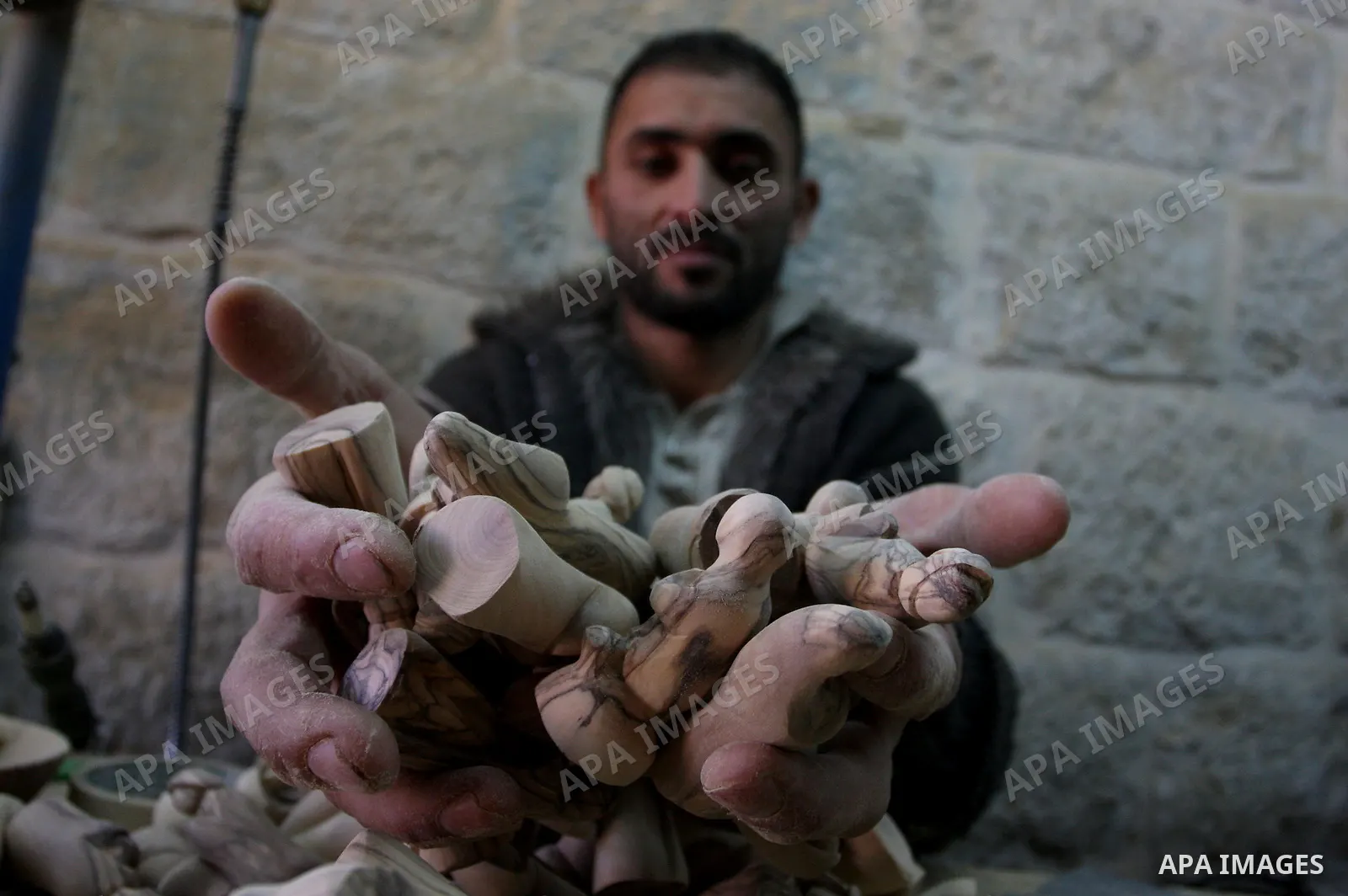 A Palestinian wood carver works on a nativity figurines are stored in an olive wood factory in the West Bank town of Bethlehem, ahead of Christmas,Thursday, Dec. 22, 2011. Photo by Issam Rimawi