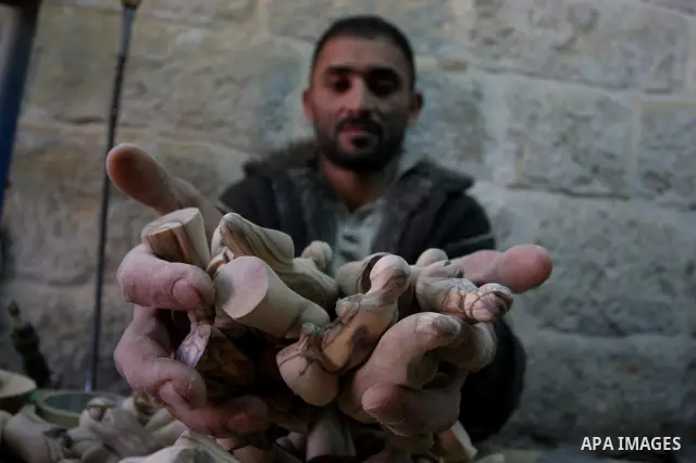 A Palestinian wood carver works on a nativity figurines are stored in an olive wood factory in the West Bank town of Bethlehem, ahead of Christmas,Thursday, Dec. 22, 2011. Photo by Issam Rimawi