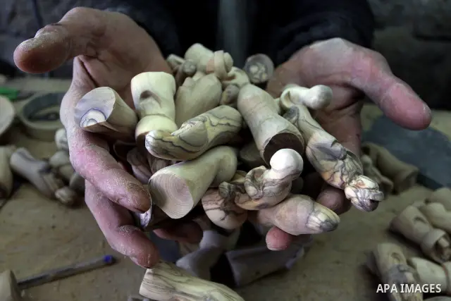A Palestinian wood carver works on a nativity figurines are stored in an olive wood factory in the West Bank town of Bethlehem, ahead of Christmas,Thursday, Dec. 22, 2011. Photo by Issam Rimawi