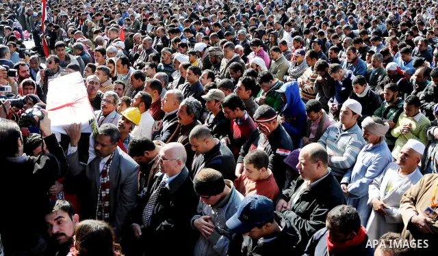 Protesters gather for Friday prayers next to a coffin bearing the national flag, symbolising Egyptians who died in the latest clashes at Tahrir Square, in Cairo December 23, 2011. Thousands of Egyptians rallied in Cairo...