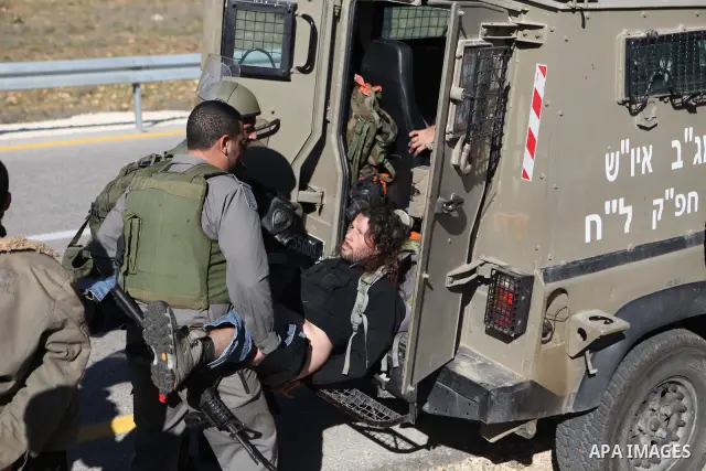A Palestinian protester is detained by Israeli soldiers during clashes at a weekly protest against a nearby Jewish settlement, in the West Bank village of Nabi Saleh, near Ramallah December 23, 2011. Some 100 demonstrato...