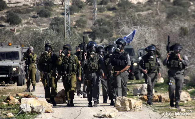 Israeli soldiers and border police firing tear gas on Palestinian ,during a protest in the village of Kufr Qaddum near the Israeli settlement of Kdumim, in the northern West Bank, Friday, Dec. 23, 2011. Photo by Wagdi Es...
