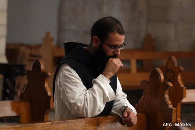 Christian pilgrims pray in the Church of the Nativity in the biblical West Bank city of Bethlehem on December 23, 2011, as Christian pilgrims started gathering in the traditional birthplace of Jesus Christ to attend the...