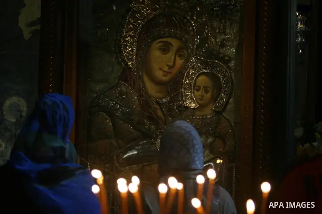 Christian pilgrims pray in the Church of the Nativity in the biblical West Bank city of Bethlehem on December 23, 2011, as Christian pilgrims started gathering in the traditional birthplace of Jesus Christ to attend the...