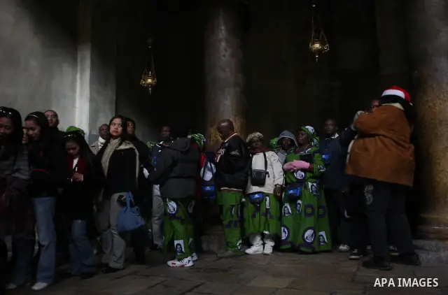 Christian pilgrims visit the Church of the Nativity in the biblical West Bank city of Bethlehem on Christmas Eve on 24 December 2011. Photo by Issam Rimawi