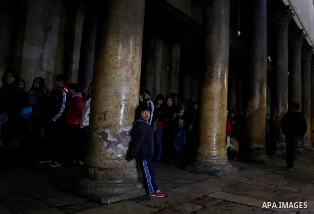 Christian pilgrims visit the Church of the Nativity in the biblical West Bank city of Bethlehem on Christmas Eve on 24 December 2011. Photo by Issam Rimawi