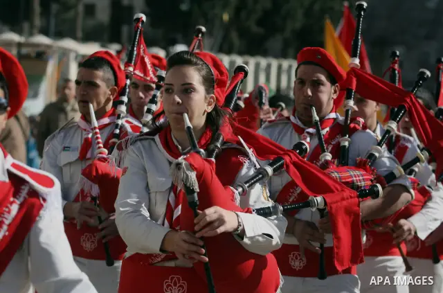 Palestinian Scouts play the bagpipes outside the Church of the Nativity while Christians gather for Christmas celebrations in the West Bank city of Bethlehem on December 24, 2011, as thousands of Christian pilgrims desce...