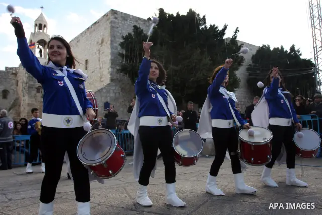 Palestinian Scouts play the bagpipes outside the Church of the Nativity while Christians gather for Christmas celebrations in the West Bank city of Bethlehem on December 24, 2011, as thousands of Christian pilgrims desce...