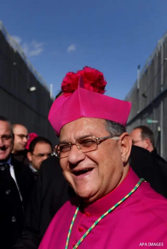 The head of the Roman Catholic Church in the Holy Land, the Latin Patriarch of Jerusalem Fuad Twal drives past the Israeli constructed separation barrier as he makes his way to the Church of the Nativity in the Biblical...