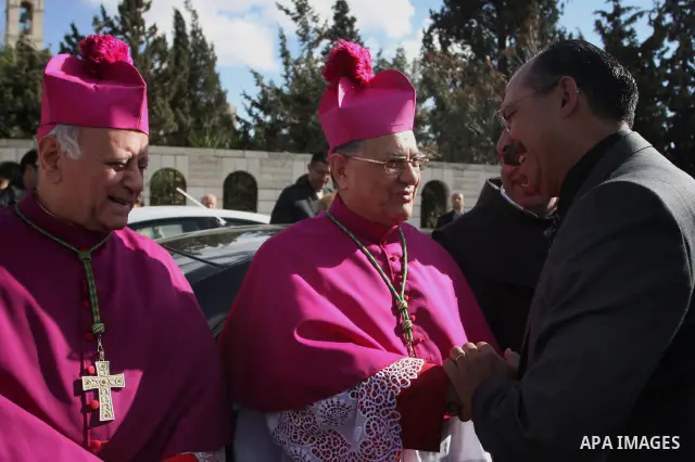 The head of the Roman Catholic Church in the Holy Land, the Latin Patriarch of Jerusalem Fuad Twal (C) makes his way to the Church of the Nativity in the Biblical West Bank city of Bethlehem, believed to be the birthplac...