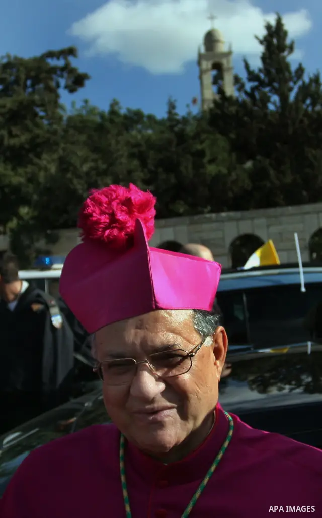 The head of the Roman Catholic Church in the Holy Land, the Latin Patriarch of Jerusalem Fuad Twal (C) makes his way to the Church of the Nativity in the Biblical West Bank city of Bethlehem, believed to be the birthplac...