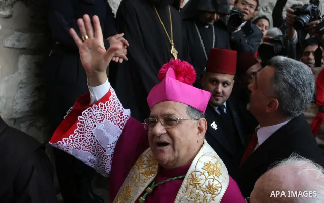 The head of the Roman Catholic Church in the Holy Land, the Latin Patriarch of Jerusalem Fuad Twal (C) makes his way to the Church of the Nativity in the Biblical West Bank city of Bethlehem, believed to be the birthplac...