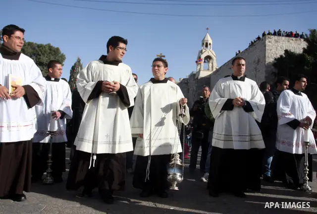 Christian pilgrims visit the Church of the Nativity in the biblical West Bank city of Bethlehem on Christmas Eve on 24 December 2011, as thousands of Christian pilgrims descended on the holy city to celebrate in Jesus' t...