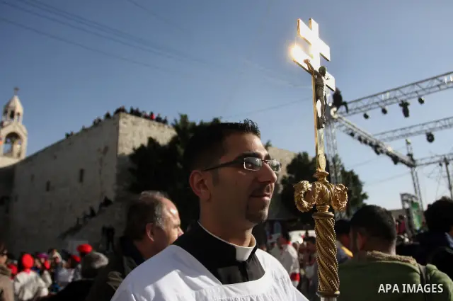 Christian pilgrims visit the Church of the Nativity in the biblical West Bank city of Bethlehem on Christmas Eve on 24 December 2011, as thousands of Christian pilgrims descended on the holy city to celebrate in Jesus' t...