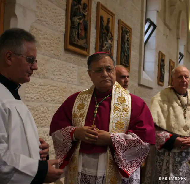 The Latin Patriarch of Jerusalem Fouad Twal waves upon his arrival to the Church of the Nativity to attend Christmas celebrations in West Bank town of Bethlehem December 24, 2011. Photo by Issam Rimawi