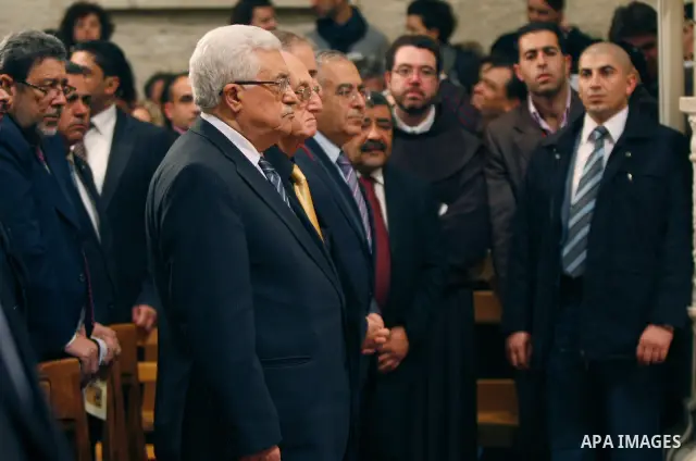 Palestinian President Mahmoud Abbas attends the Christmas midnight Mass at the Church of the Nativity, traditionally believed to be the birthplace of Jesus Christ, in the West Bank town of Bethlehem early Sunday, Dec. 25...