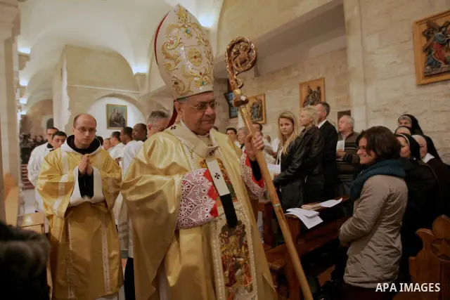 Latin Patriarch of Jerusalem Fouad Twal leads the Christmas midnight Mass at the Church of the Nativity, traditionally believed to be the birthplace of Jesus Christ, in the West Bank town of Bethlehem early Sunday, Dec....