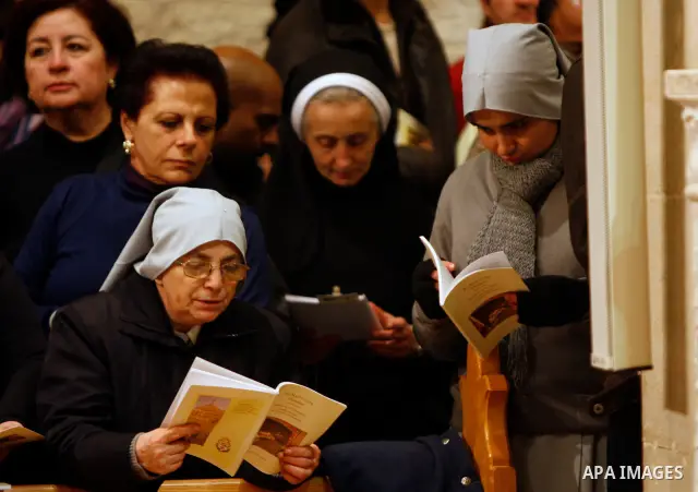 Nuns read prayers during the Christmas midnight Mass at the Church of the Nativity, traditionally believed to be the birthplace of Jesus Christ, in the West Bank town of Bethlehem early Sunday, Dec. 25, 2011. (APAimages...