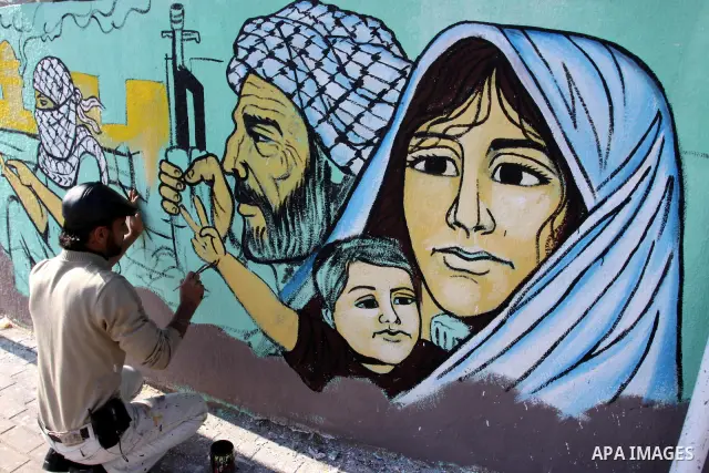 Palestinian Artists take part in paint a murals in the third anniversary of the Israeli war on Gaza Strip, in Gaza city on Dec. 27,2011. Photo by Mohammed Asad