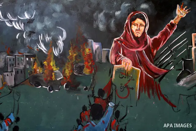 Palestinian Artists take part in paint a murals in the third anniversary of the Israeli war on Gaza Strip, in Gaza city on Dec. 27,2011.Photo by Mohammed Asad