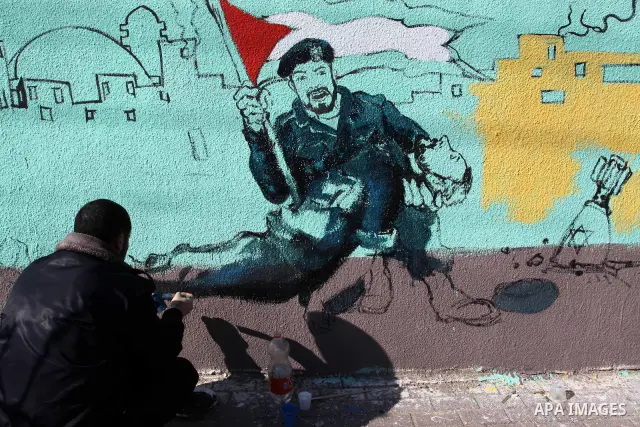 Palestinian Artists take part in paint a murals in the third anniversary of the Israeli war on Gaza Strip, in Gaza city on Dec. 27,2011. Photo by Mohammed Asad