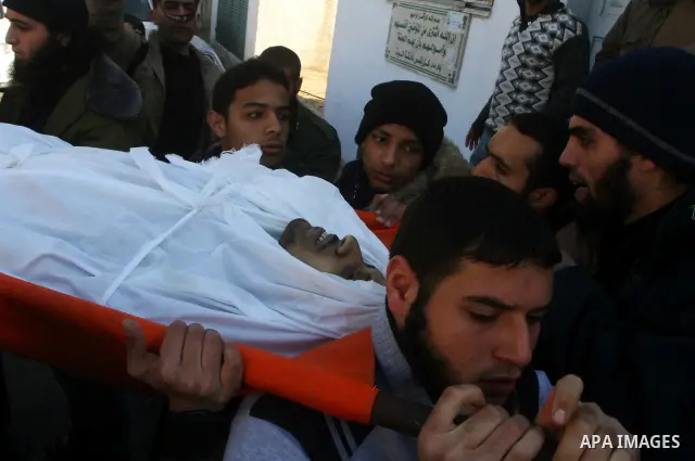 Palestinian mourners carry the body of Abdallah al-Telbani, 22-years-old, during his funeral in Gaza City on December 28, 2011, after he was killed following an Israeli airstrike. Photo by Ashraf Amra