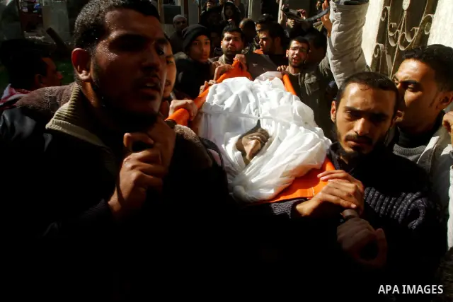 Palestinian mourners carry the body of Abdallah al-Telbani, 22-years-old, during his funeral in Gaza City on December 28, 2011, after he was killed following an Israeli airstrike. Photo by Ashraf Amra