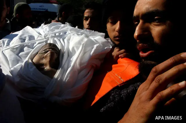 Palestinian mourners carry the body of Abdallah al-Telbani, 22-years-old, during his funeral in Gaza City on December 28, 2011, after he was killed following an Israeli airstrike. Photo by Ashraf Amra