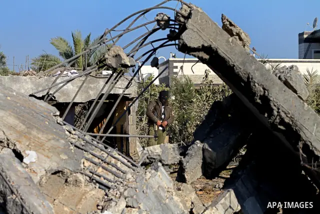 Palestinians survey an Islamic Jihad training camp damaged by an Israeli air strike in Gaza December 29, 2011. The Israeli army confirmed that it targeted two sites in Gaza, including the training camp, and added that th...