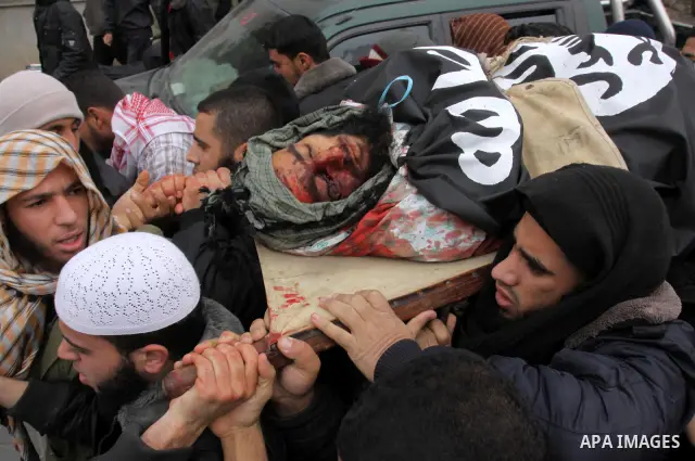 Palestinians carry the body of militant Momen Abu Daf during his funeral in Gaza City December 30, 2011. Israel killed the leader of an al Qaeda-inspired faction in the Gaza Strip on Friday, accusing him of involvement i...