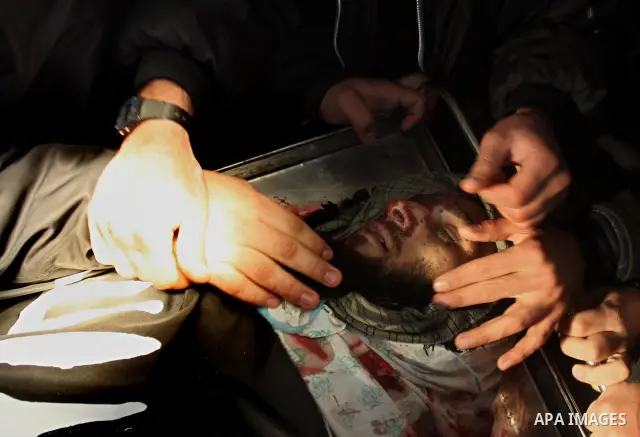 Palestinians look at the body of militant Momen Abu Daf during his funeral at a mosque in Gaza City December 30, 2011. Israel killed the leader of an al Qaeda-inspired faction in the Gaza Strip on Friday, accusing him of...