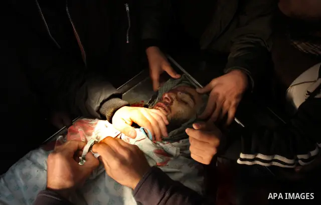 Palestinians look at the body of militant Momen Abu Daf during his funeral at a mosque in Gaza City December 30, 2011. Israel killed the leader of an al Qaeda-inspired faction in the Gaza Strip on Friday, accusing him of...